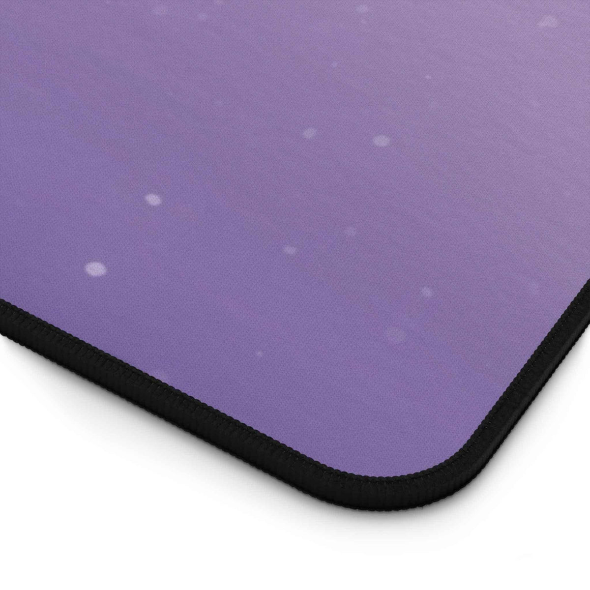 Edge close-up of high-quality neoprene desk mat with alien space art