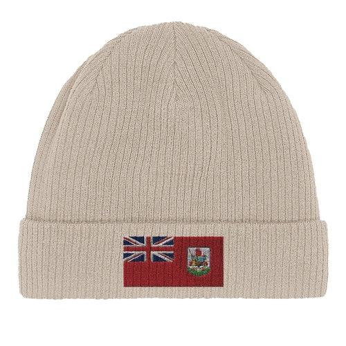 Unfolded green organic cotton beanie laid flat with visible Bermuda flag patch