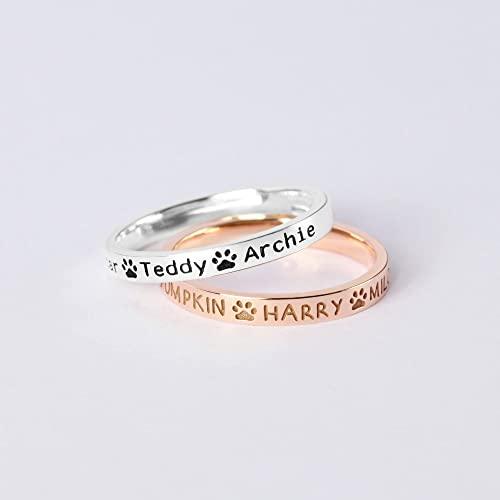 Close-up of sterling silver dog name ring with custom engraved pet names.