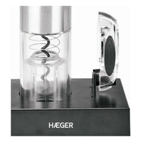 Electric corkscrew placed upright showing black metal body and charging base