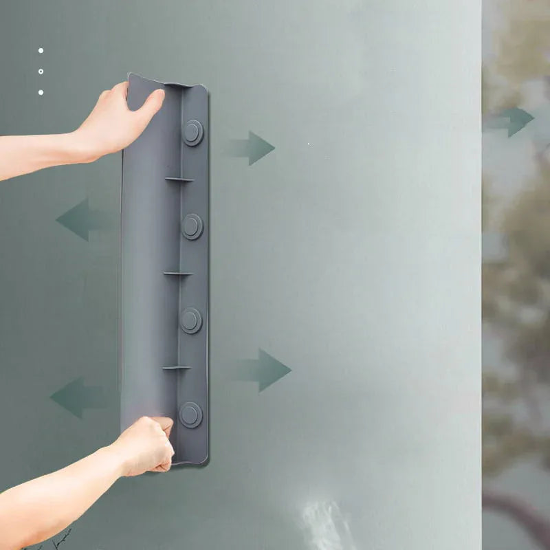 Close-up of translucent silicone water baffle with water droplets on surface in sink.