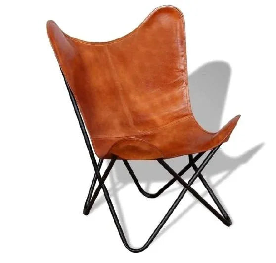 Brown leather butterfly lounge chair with solid iron frame on wooden floor in modern room