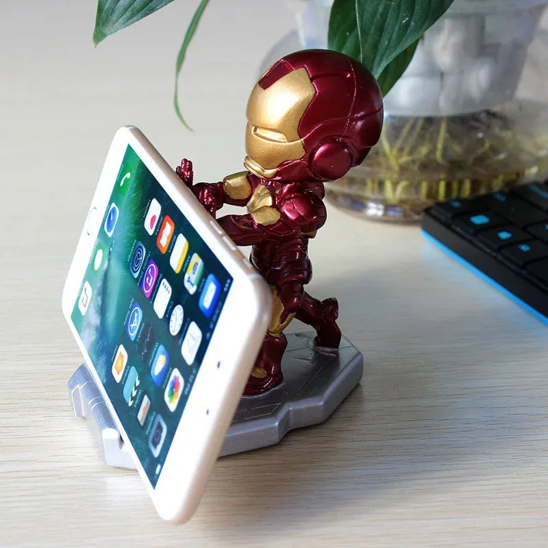 Side angle of Iron Man phone stand showing detailed armor design holding a smartphone upright.