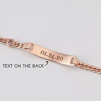 Child wearing a custom sterling silver bracelet with name and birthstone, shown on small wrist.