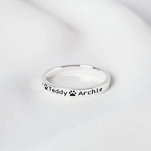 18K gold plated dog name ring displayed on a wooden surface.