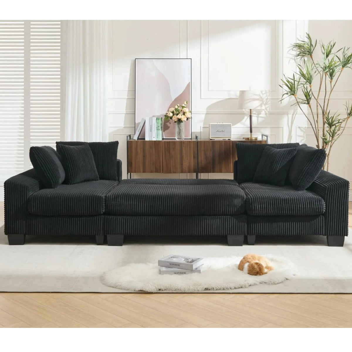 Modern black U-shaped sleeper sofa with corduroy upholstery, plush cushions, and a pull-out bed for four.