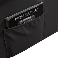 Detailed stitching and plush cushioning on the armchair's armrest and footrest