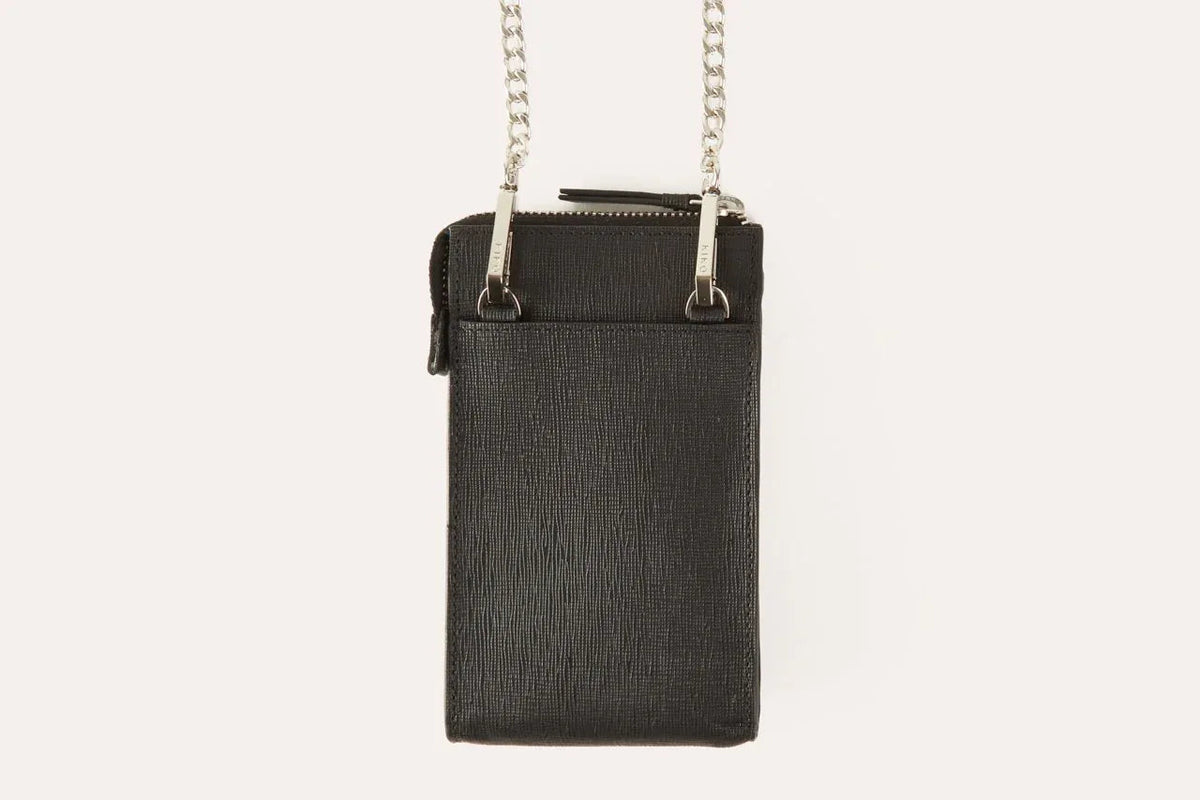 Pink crossbody phone wallet shown from side highlighting slim 1 inch depth.