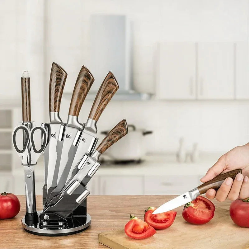 Close-up of kitchen knives with wood color handles arranged near the wooden rotating stand.