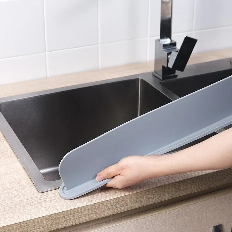 Kitchen sink with water baffle installed showing splash-proof protection and clean countertop.