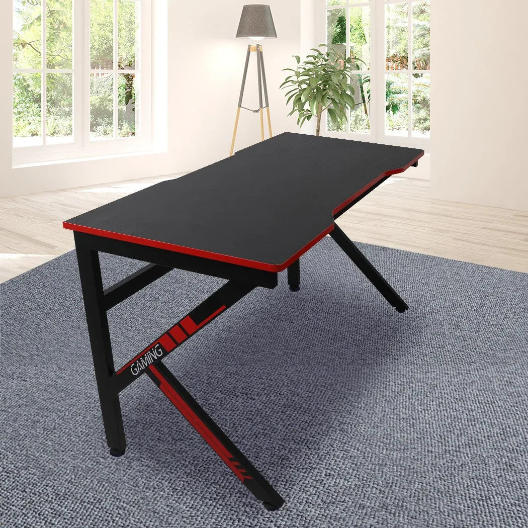 Close-up of gaming desk's smooth carbon fiber surface with subtle reflective texture.