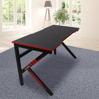 Close-up of gaming desk's smooth carbon fiber surface with subtle reflective texture.