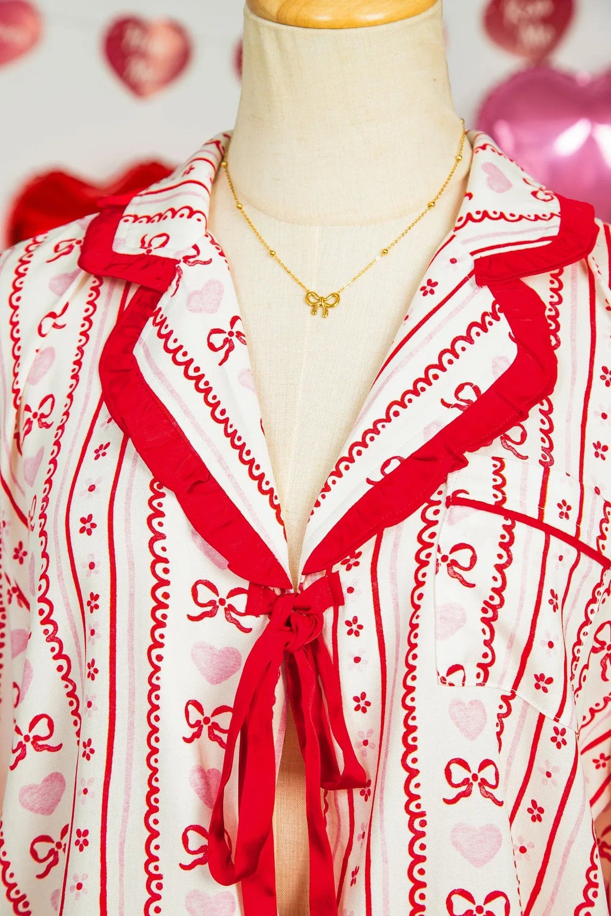 Pajama shorts laid flat featuring stripes and heart prints with ribbon tie detail.