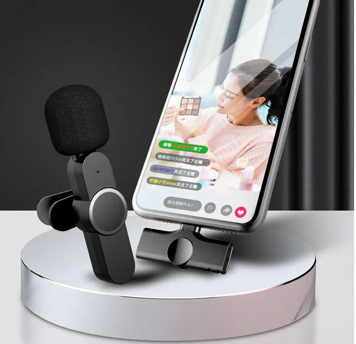 Close-up of the wireless lapel microphone showing the clip and microphone head.