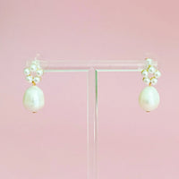 Side angle view of a Blooming Freshwater Pearl Drop Earring showcasing its elegant pearl drop and circular bead arrangement.