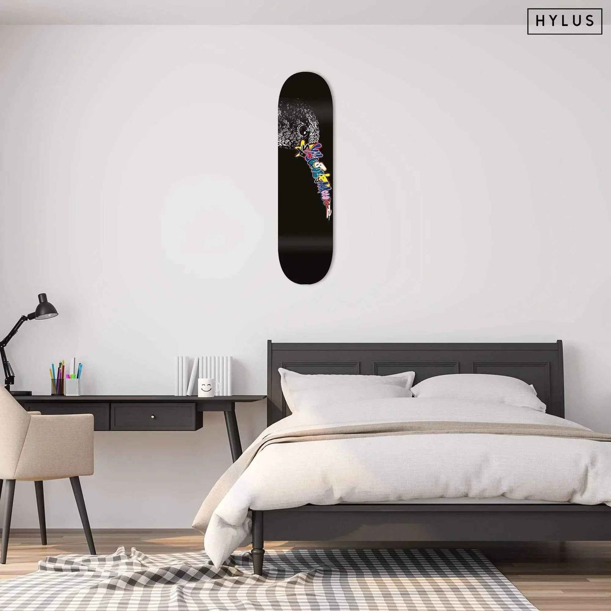 Graffiti hummingbird skateboard mounted on a bedroom wall above a bed