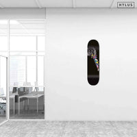 Office space showing graffiti hummingbird skateboard hanging on white wall