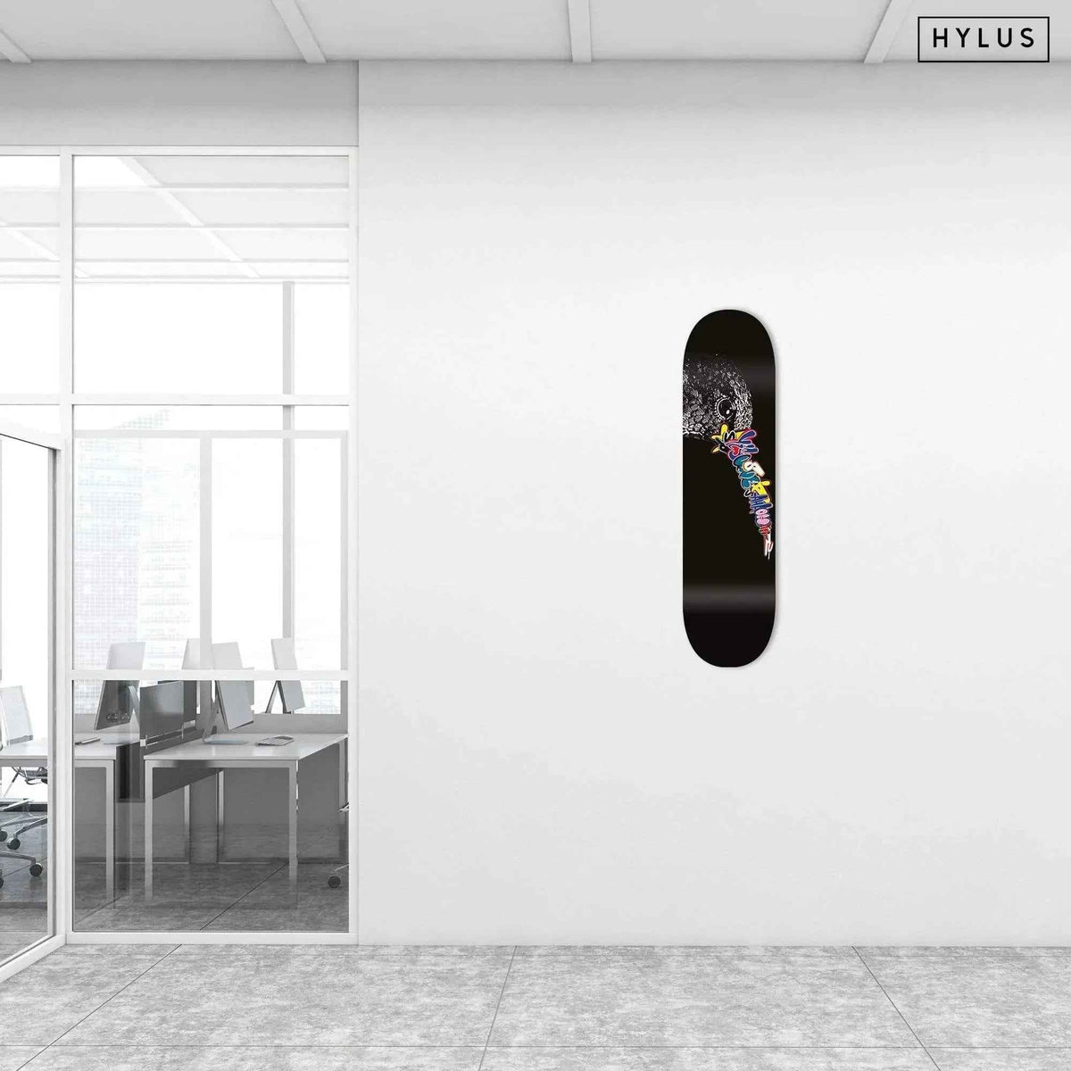 Office space showing graffiti hummingbird skateboard hanging on white wall
