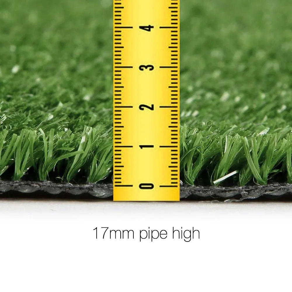 Wide view of artificial turf covering a yard, showing vibrant and dense green grass blades.