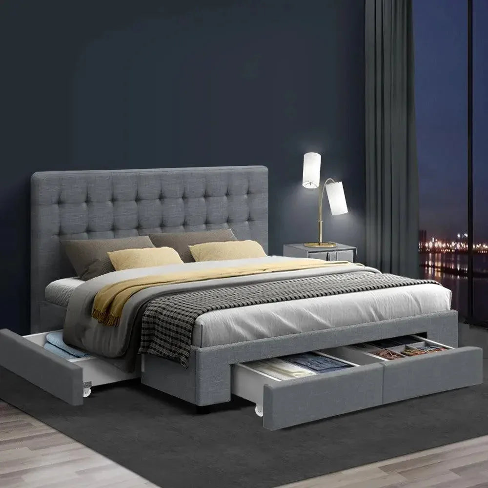 Grey fabric bed frame with storage drawers closed, showing clean tailored design details.