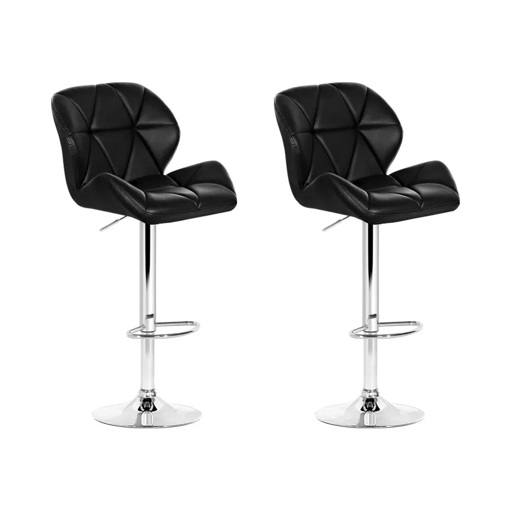 Two modern black faux leather kitchen bar stools with chrome bases and footrests side by side