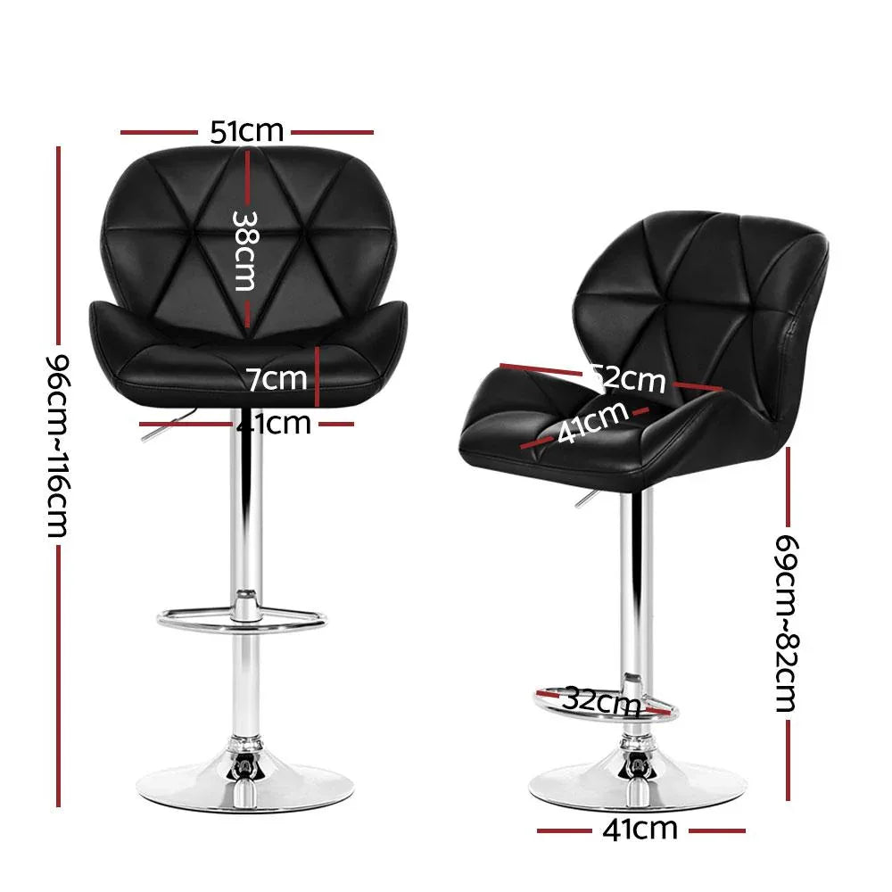 Close-up of black faux leather seat on a chrome base kitchen bar stool with footrest.