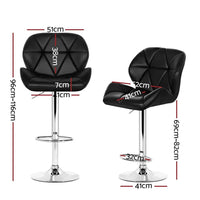 Close-up of black faux leather seat on a chrome base kitchen bar stool with footrest.