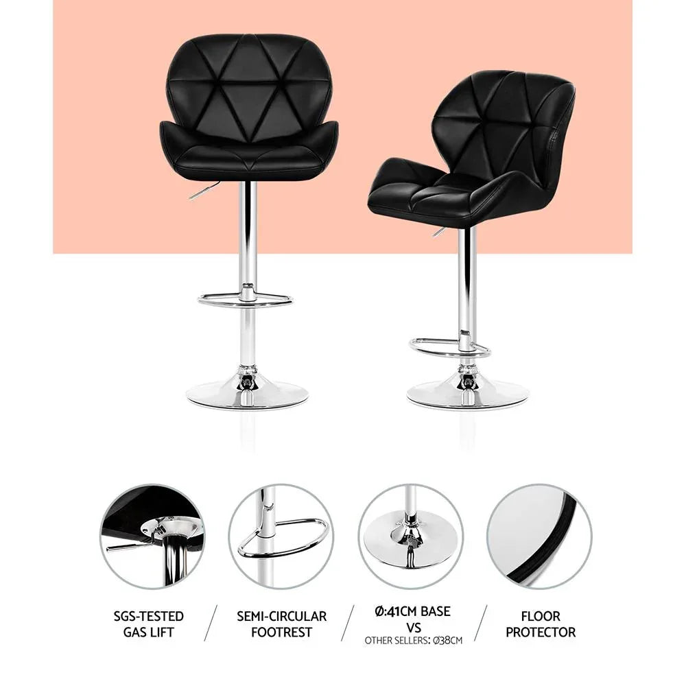 Chrome base and gas lift mechanism under the black faux leather kitchen bar stool seat.