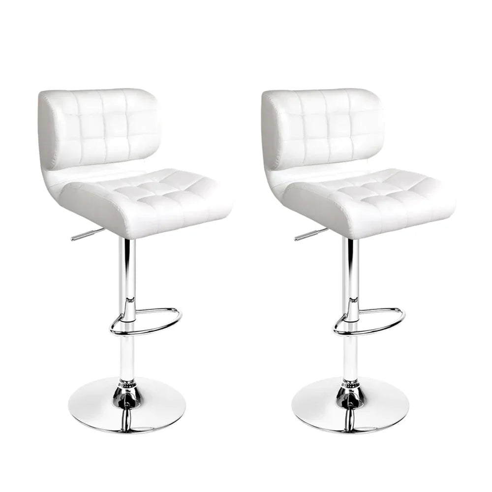 Two white PU leather bar stools with chrome bases and gas lift levers, shown in a bright setting.