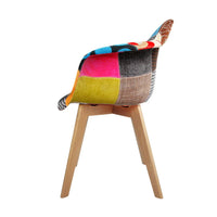 Back view of a beige fabric dining chair with wooden legs against white backdrop.