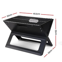 Side view of portable charcoal BBQ grill showing sturdy three-leg design and handle