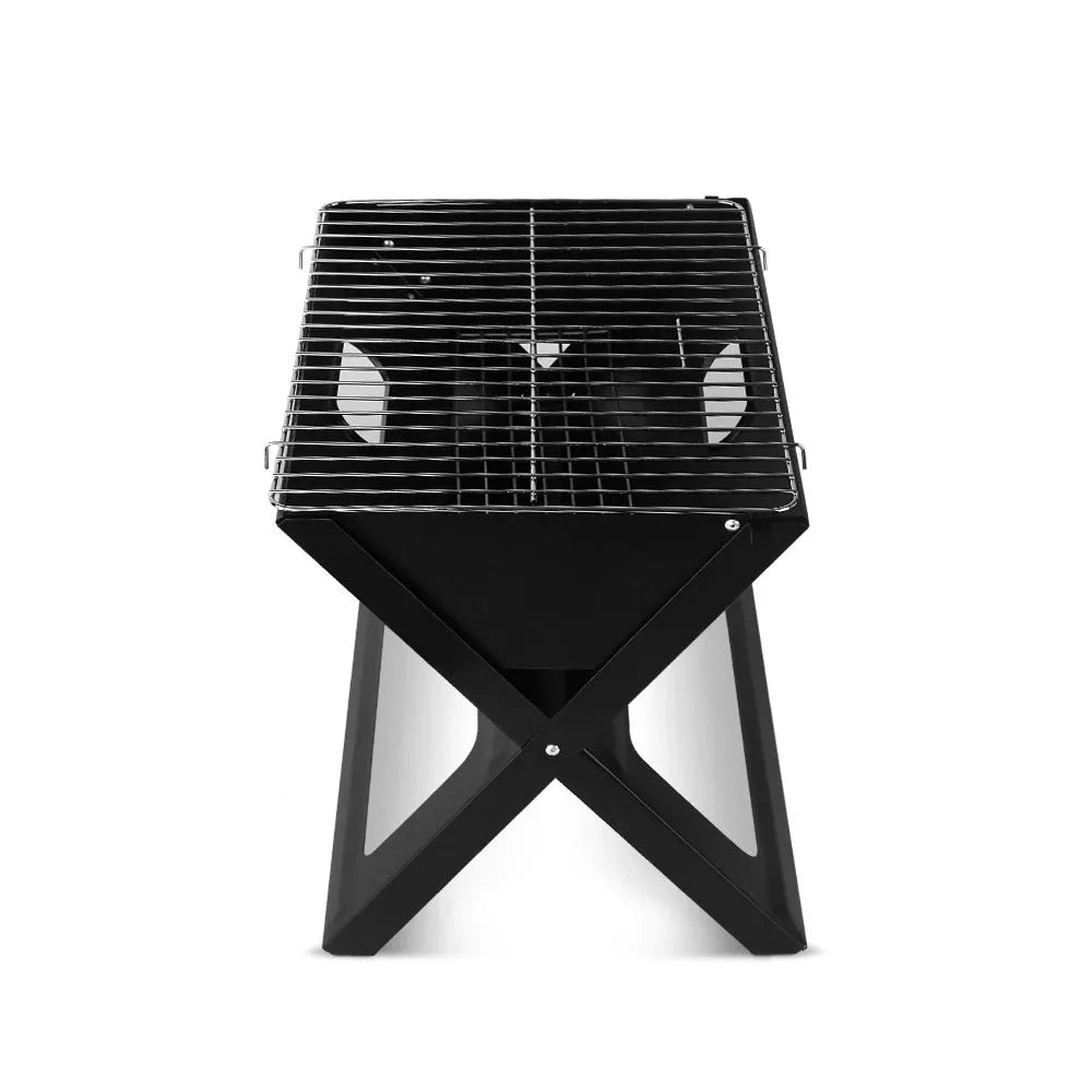 Open portable charcoal BBQ grill with chrome-plated grill rack and charcoal inside