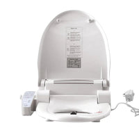 Person's hand holding the remote control for the electronic bidet toilet seat.