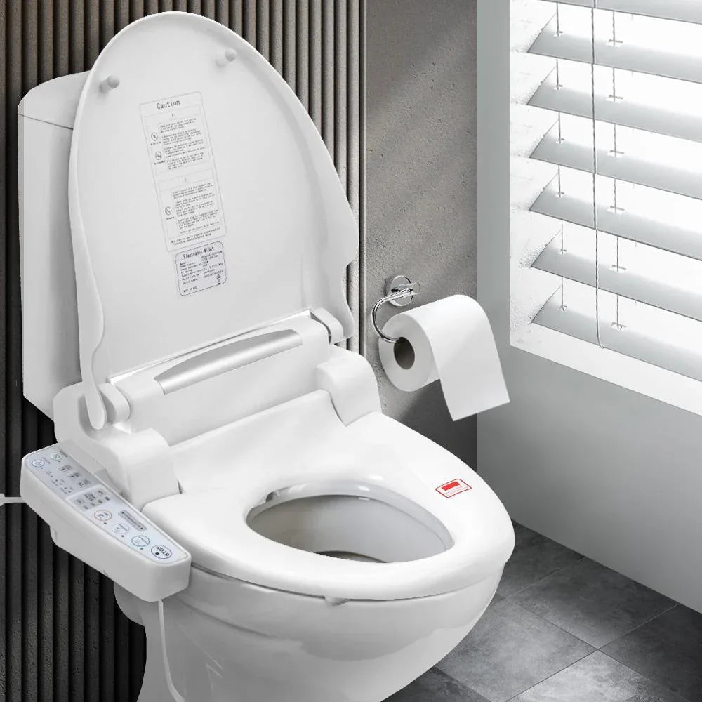 White bidet toilet seat with electronic control panel beside traditional toilet.