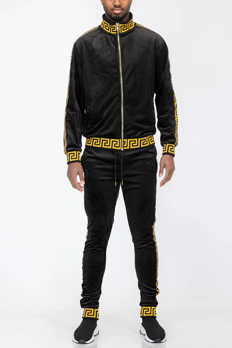 Close-up of black and gold velour track jacket showing fabric texture and zipper details.