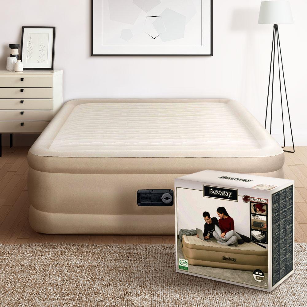 Person pressing down on the comfortable surface of the inflated Bestway queen air bed.