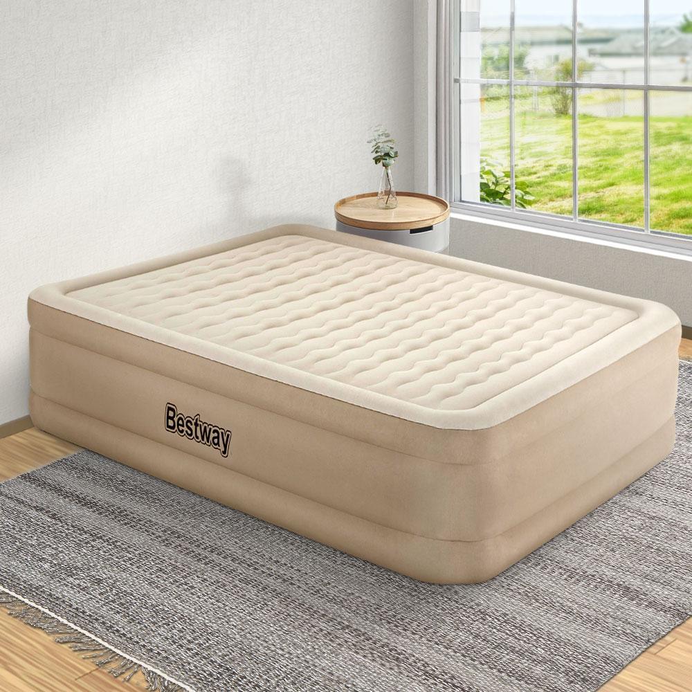 Fully inflated Bestway queen air bed placed in a bedroom with a pillow on top.