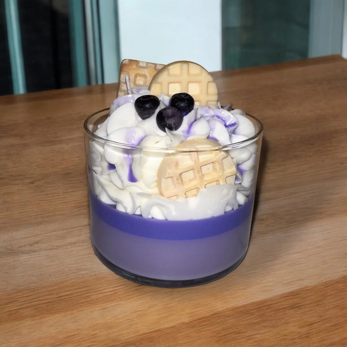 Pair of Blueberry Waffle scented candles arranged side by side on a wooden surface.