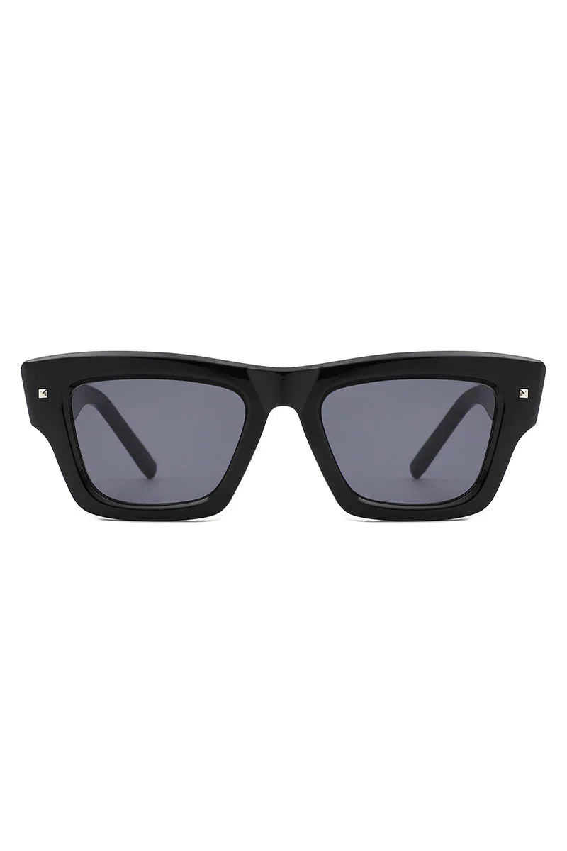 Close-up of retro cat eye square sunglasses with dark lenses on white background.