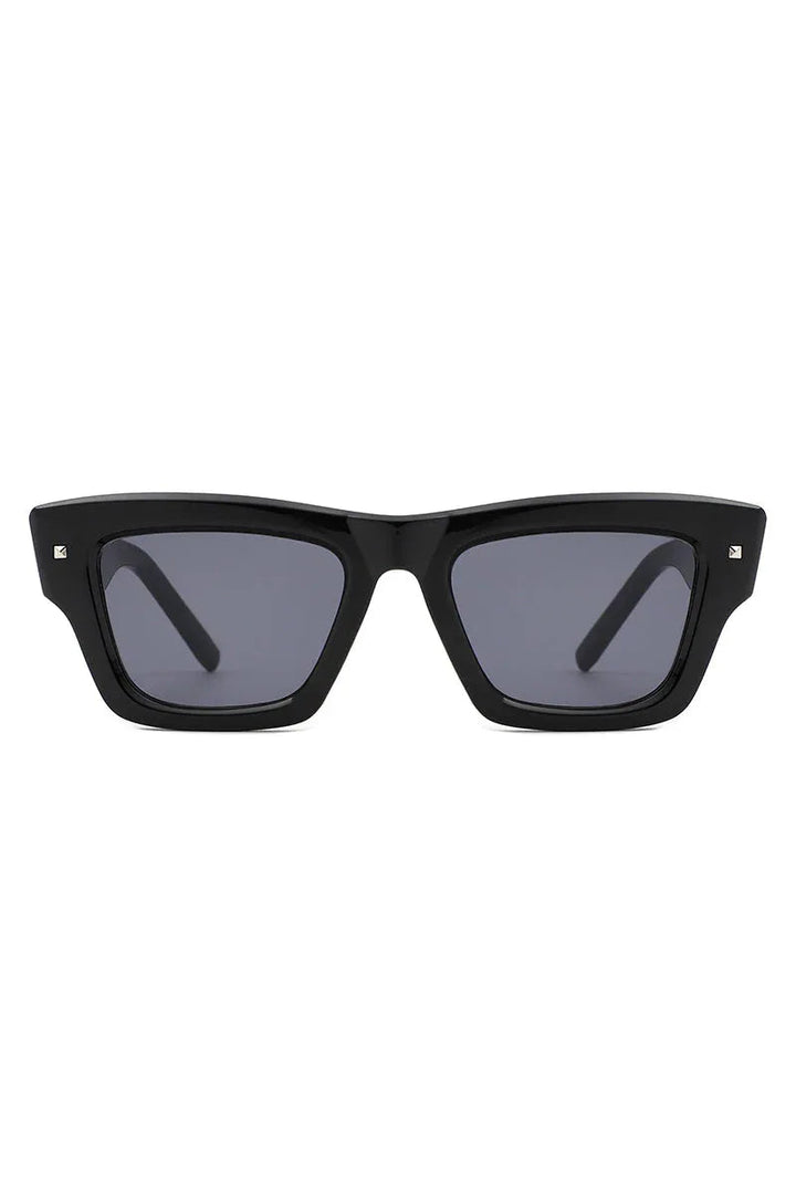 Close-up of retro cat eye square sunglasses with dark lenses on white background.