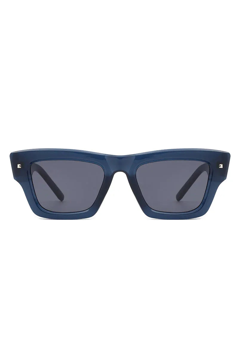 Sunglasses laid flat with square cat eye frame and dark tinted lenses.