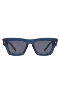 Sunglasses laid flat with square cat eye frame and dark tinted lenses.