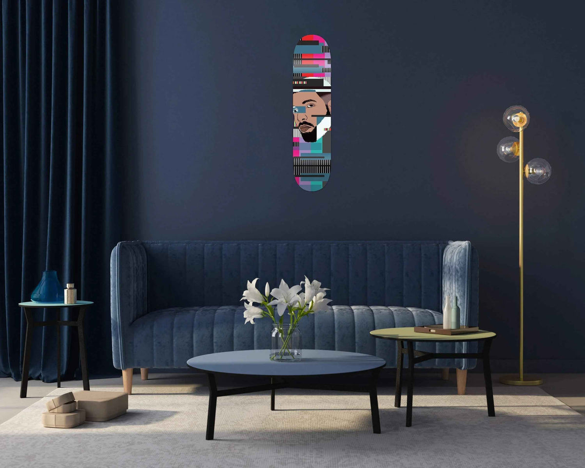 Drake Skateboard mounted on a living room wall with modern decor and couch below it.