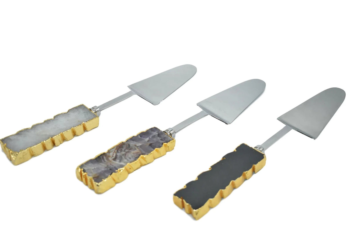Cake server with gold trim and amethyst handle on white background