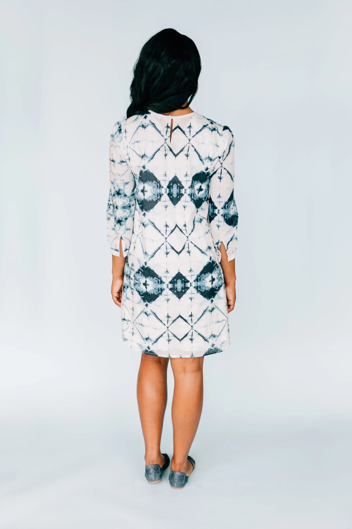 Back view of model in Inkwell Dress showing keyhole button closure and flowing fabric.