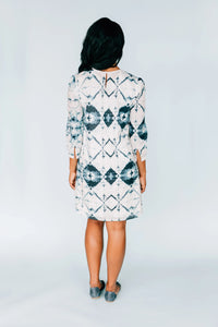 Back view of model in Inkwell Dress showing keyhole button closure and flowing fabric.
