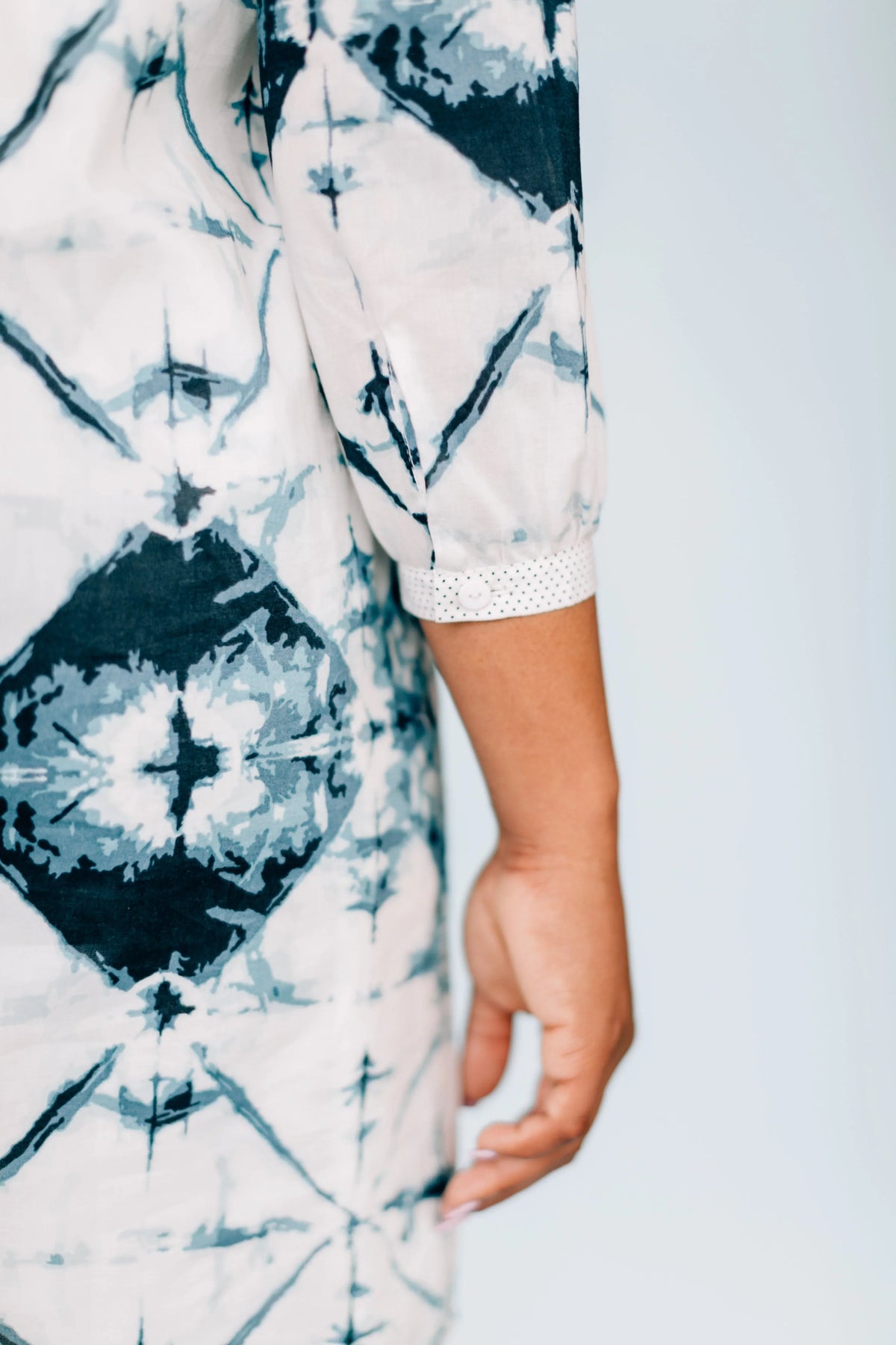 Close-up of Inkwell Dress fabric showcasing bold tie dye and polka dot details.