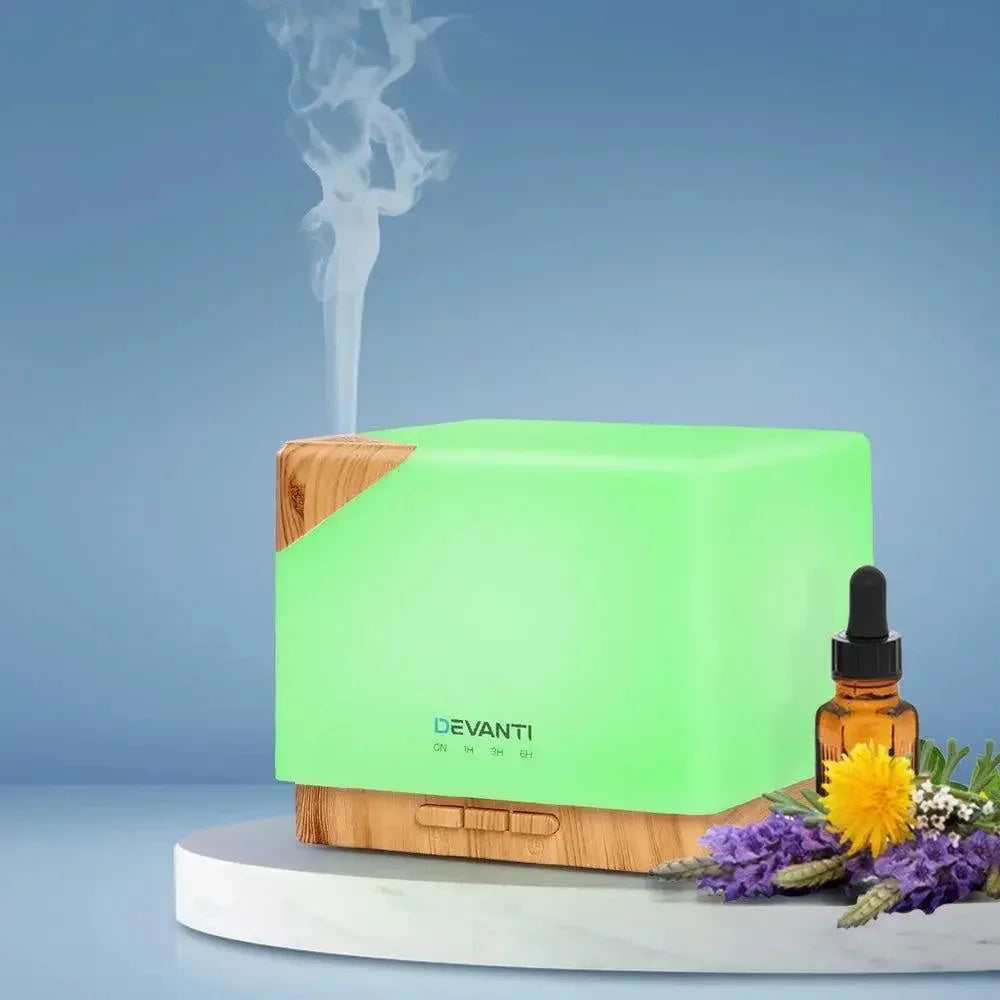 DEVANTi Aroma Diffuser beside essential oil bottle and decorative items