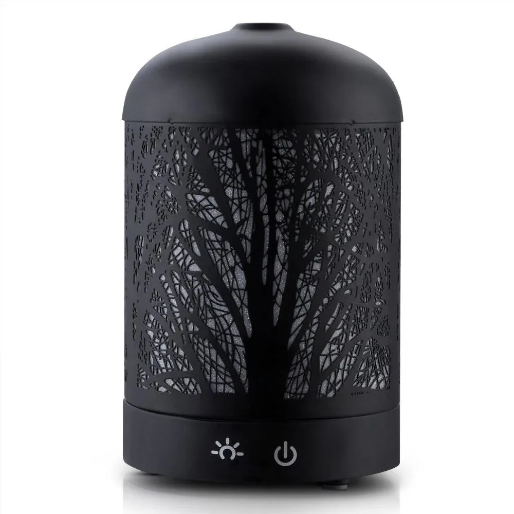 Side view of black aromatic diffuser showing iron art style design with mist coming out.