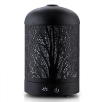 Side view of black aromatic diffuser showing iron art style design with mist coming out.